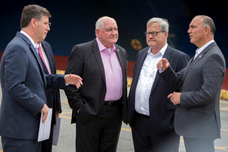 U.S. Secretary of Agriculture Sonny Perdue (C), Canadian Agriculture Minister Lawrence MacAulay (2nd R) and Mexican Secretary of Agriculture José Calzada Rovirosa (R) listen to Georgia Ports Authority Executive Director Griff Lynch (2nd L) during a tour of the Port of Savannah in Savannah, Georgia, U.S. on June 20, 2017.   Courtesy Stephen B. Morton/Georgia Ports Authority/Handout via REUTERS