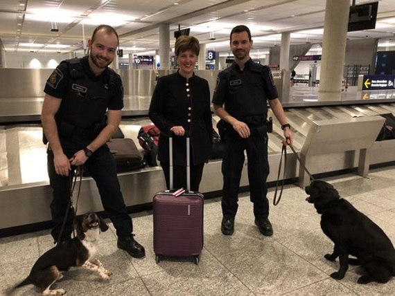 Agriculture Minister Marie-Claude Bibeau, shown here March 14, 2019 at the Montreal-Trudeau airport with Canadian border services officers and detector dogs, announced new funding to expand Canada’s detector dog corps. (CNW Group/CFIA)