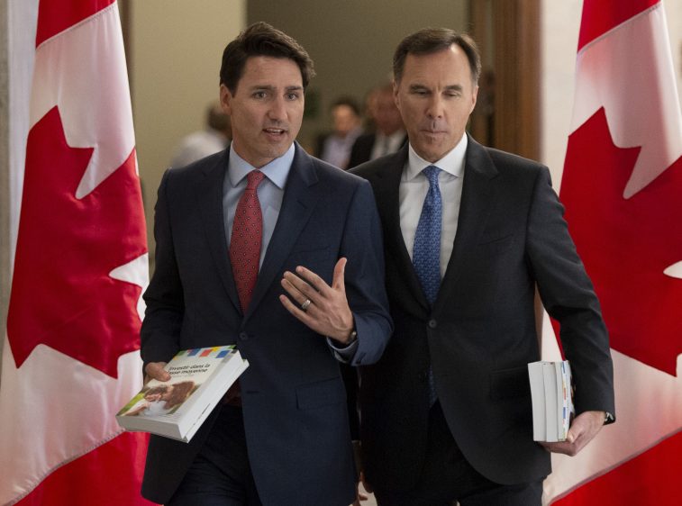 Prime Minister Justin Trudeau and Finance Minister Bill Morneau speak as they walk to the House of Commons in Ottawa, Tuesday March 19, 2019. THE CANADIAN PRESS/Sean Kilpatrick