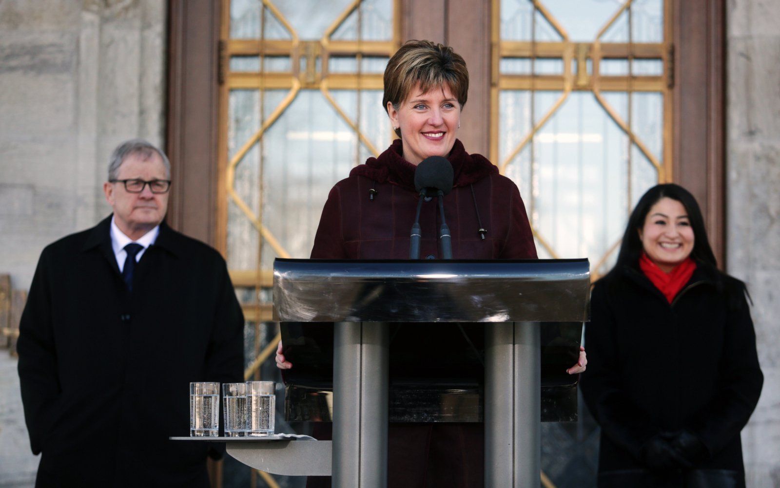 Agriculture Minister Marie-Claude Bibeau speaks to reporters, alongside cabinet colleagues Lawrence MacAuley and Maryam Monsef outside Rideau Hall in Ottawa, following a cabinet shuffle on March 1, 2019. Photo by Andrew Meade