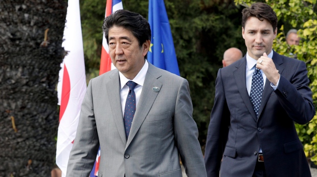 Japanese Prime Minister Shinzo Abe, left, and Canadian Prime Minister Justin Trudeau walk in the Sicilian town of Taormina, Italy. (AP Photo/Andrew Medichini)