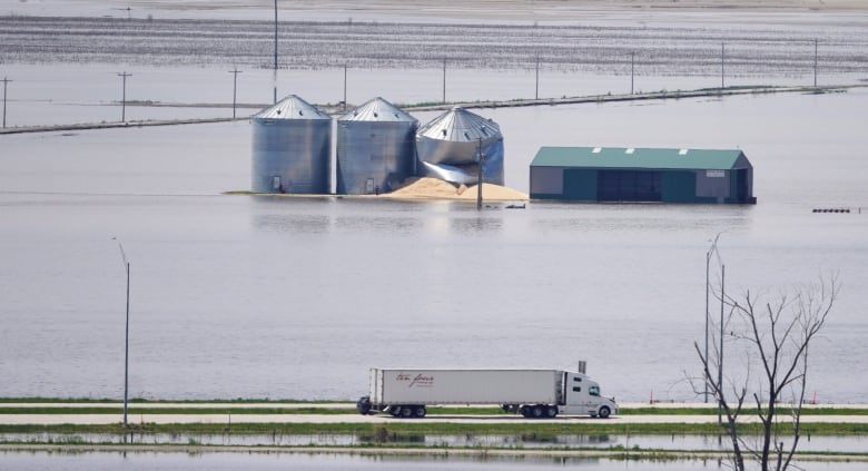 Grain bins stand in floodwaters (Nati Harnik/Associated Press)