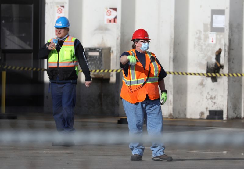 FILE PHOTO: Employees wear face masks at the JBS USA meat packing plant, where two members of the staff have died of coronavirus disease (COVID-19), as it remains operational in Greeley, Colorado, U.S. April 8, 2020. REUTERS/Jim Urquhart