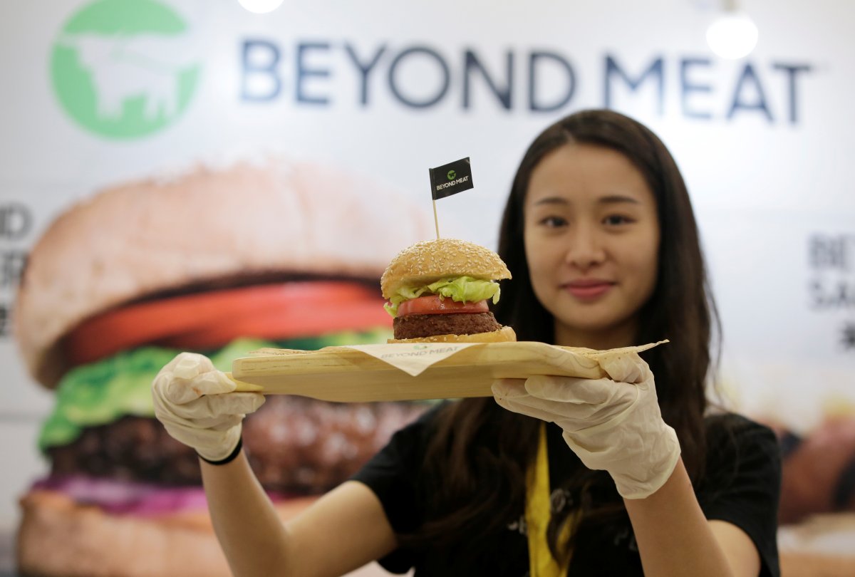 ARCHIVE PHOTO: A staff member displays a burger with a Beyond Meat plant-based patty at VeggieWorld fair in Beijing, China November 8, 2019. REUTERS/Jason Lee