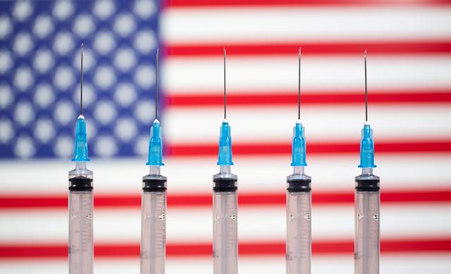 Syringes are seen in front of a displayed U.S. flag in this illustration taken November 10, 2020(Reuters)