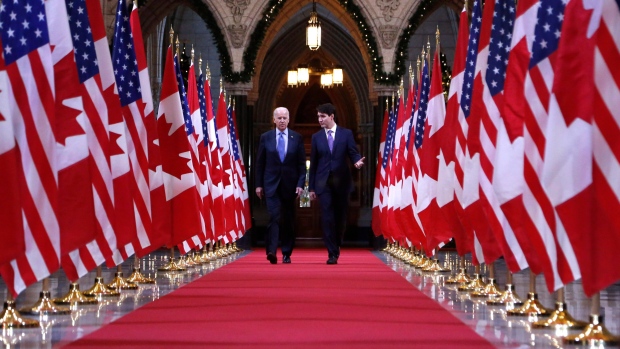 Prime Minister Justin Trudeau and US vice-president Joe Biden walk down the Hall of Honour on Parliament Hill in Ottawa - THE CANADIAN PRESS/Patrick Doyle