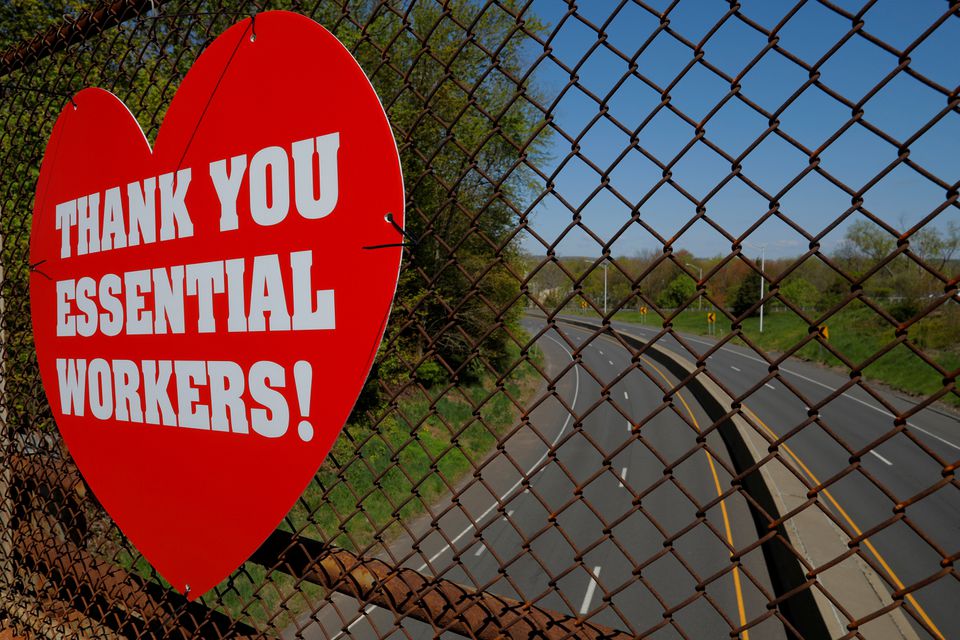 A heart-shaped sign reading "Thank you essential workers!" is pictured on an overpass amid the coronavirus disease (COVID-19) outbreak in Middletown, Connecticut, U.S., May 13, 2020. REUTERS/Brian Snyder/File Photo