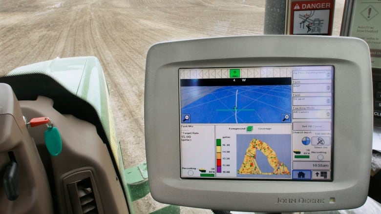 A computer monitor is seen inside a GPS-equipped John Deere tractor. As farm use of technology and smart devices grows, experts say more needs to be done to protect against cyberattacks that could threaten food security. (Seth Perlman/The Associated Press)