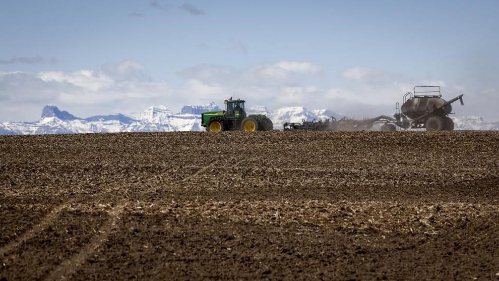 In 2021, farmers were thrown a big curveball in the form of the severe drought that withered crops across Western Canada. A family plants their wheat crop with a seeding rig, near Cremona, Alta., Friday, May 6, 2022. THE CANADIAN PRESS/Jeff McIntosh