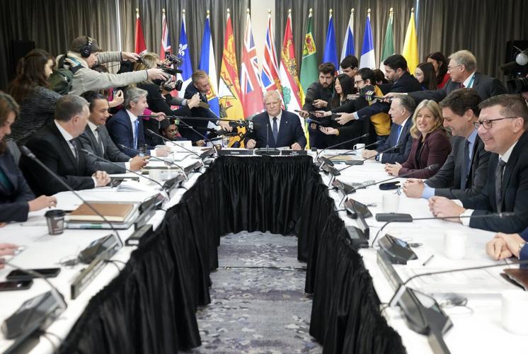 Ontario Premier Doug Ford, centre, is swarmed by the media as they ask him about finance Minister Chrystia Freeland resigning from Prime Minister Justin Trudeau's cabinet during the fall meetings of Canada's premiers hosted by Ontario in Toronto, Monday, Dec. 16, 2024. THE CANADIAN PRESS/Nathan Denette