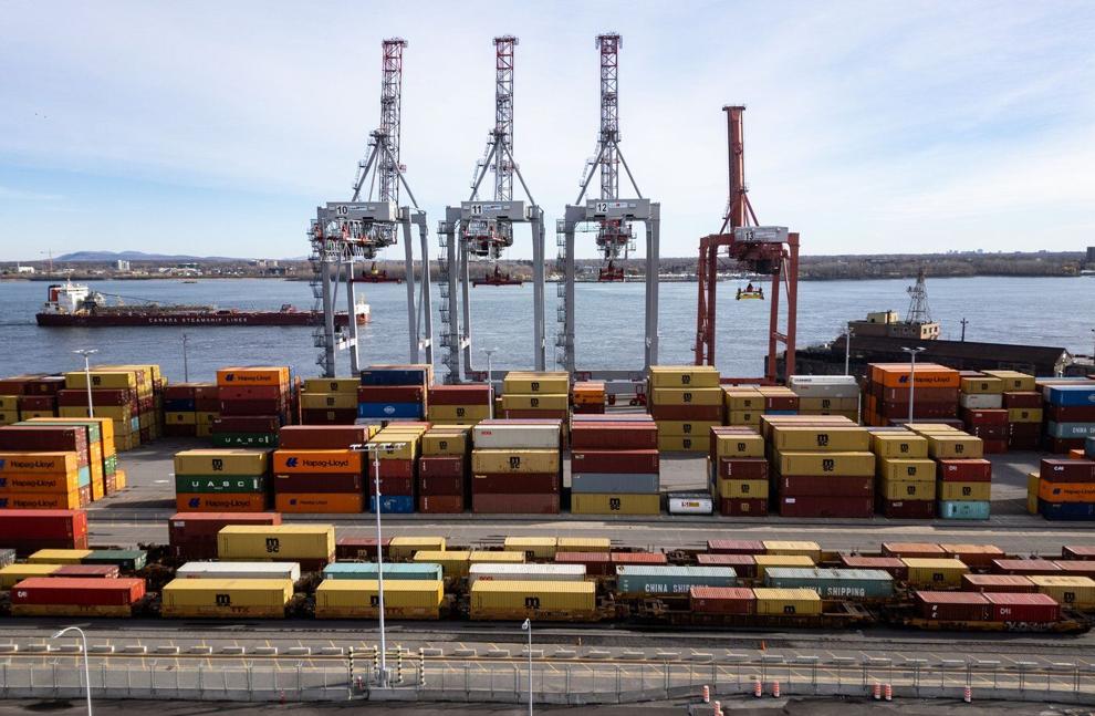 An aerial view shows a ship sailing past the Port of Montreal in Montreal on Thursday, Nov.14, 2024. THE CANADIAN PRESS/Christinne Muschi
